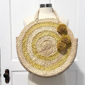 Round woven straw bag with detachable Pom Pom charm
